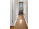Hallway features wood floors and a staircase to the upper level, illuminated by natural light at 931 Cornwall Sw Ct, Marietta, GA 30064