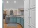 Bright kitchen featuring blue cabinets, granite countertops, and an abundance of white storage cabinets at 931 Cornwall Sw Ct, Marietta, GA 30064