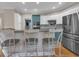Kitchen with breakfast bar featuring granite countertops, stainless appliances, and seating for three at 931 Cornwall Sw Ct, Marietta, GA 30064