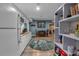 Bright kitchenette open to the living area with white cabinets and light wood floors and a modern circular rug at 931 Cornwall Sw Ct, Marietta, GA 30064