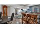 Open kitchenette with granite counters, wood floors, and a dining table adjacent to a home office desk space at 931 Cornwall Sw Ct, Marietta, GA 30064
