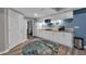 Cozy kitchenette with white cabinets, granite counters, a microwave, and a trendy circular area rug at 931 Cornwall Sw Ct, Marietta, GA 30064