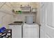 Functional laundry room with modern washer and dryer, wire shelving, and ample storage at 931 Cornwall Sw Ct, Marietta, GA 30064