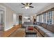 Inviting living room features a large sectional sofa, area rug, and a ceiling fan at 931 Cornwall Sw Ct, Marietta, GA 30064