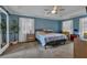 Spacious primary bedroom suite features a tray ceiling, carpeted floor, and large windows at 931 Cornwall Sw Ct, Marietta, GA 30064