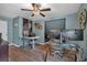Home office boasting blue walls, hardwood floors, large windows, ceiling fan, and a dual work area setup at 931 Cornwall Sw Ct, Marietta, GA 30064