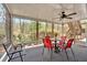 Comfortable screened in porch with outdoor furniture and a ceiling fan with a wooded view at 931 Cornwall Sw Ct, Marietta, GA 30064