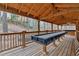 A backyard pavilion features a shuffleboard table and bench seating at 931 Cornwall Sw Ct, Marietta, GA 30064