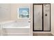 Bright bathroom featuring a tub and glass shower at 2105 Caswell Cir, Marietta, GA 30060
