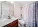 Well-lit bathroom with a shower and tub combo with vanity at 2105 Caswell Cir, Marietta, GA 30060