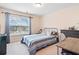 Bright bedroom featuring a cozy bed, desk, and large window at 2105 Caswell Cir, Marietta, GA 30060