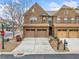 Attractive brick townhome featuring attached garages and well-maintained landscaping at 2105 Caswell Cir, Marietta, GA 30060