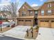 Charming brick townhome featuring a two-car garage and well-maintained landscaping at 2105 Caswell Cir, Marietta, GA 30060