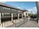 View from the balcony that overlooks rear parking of the townhome featuring gray siding and black framed windows at 6682 Sterling Dr, Atlanta, GA 30328