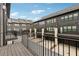 View from the balcony overlooking rear parking of the townhome featuring gray siding and black framed windows at 6682 Sterling Dr, Atlanta, GA 30328