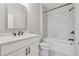 Well-lit bathroom features a shower and tub combination and white marbled tiling at 6682 Sterling Dr, Atlanta, GA 30328
