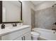 Bright bathroom with a tub shower combo, tiled walls, and a vanity with dark hardware at 6682 Sterling Dr, Atlanta, GA 30328
