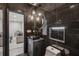 Contemporary bathroom featuring dark marble tile, modern fixtures, and stylish lighting at 6682 Sterling Dr, Atlanta, GA 30328