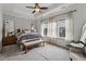 Spacious bedroom featuring a tray ceiling, ceiling fan, and bright, natural light at 6682 Sterling Dr, Atlanta, GA 30328