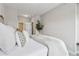 Neutral bedroom featuring a large bed, decorative pillows, and easy access to the attached bathroom at 6682 Sterling Dr, Atlanta, GA 30328