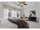 Neutral bedroom with tray ceiling, ceiling fan, carpet, and bright windows at 6682 Sterling Dr, Atlanta, GA 30328