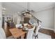 Open-concept dining room with stylish lighting, hardwood floors, and seamless flow to kitchen and living areas at 6682 Sterling Dr, Atlanta, GA 30328