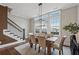 Elegant dining room with large windows, stylish chandelier, and hardwood floors next to stairs at 6682 Sterling Dr, Atlanta, GA 30328