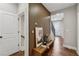 Stylish hallway with wood accent wall, hardwood floors, and a bench with decorative pillows and art at 6682 Sterling Dr, Atlanta, GA 30328