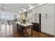 Bright kitchen with white cabinets, stainless steel appliances, dark island, and adjacent dining area at 6682 Sterling Dr, Atlanta, GA 30328
