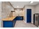 Modern kitchen featuring butcher block countertops, blue cabinetry, and stainless steel appliances at 6682 Sterling Dr, Atlanta, GA 30328
