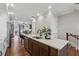 Modern kitchen island with white countertops, dark wood cabinets, stainless steel appliances, and barstool seating at 6682 Sterling Dr, Atlanta, GA 30328