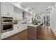 Modern kitchen featuring white cabinetry, stainless steel appliances, and a large island with seating at 6682 Sterling Dr, Atlanta, GA 30328