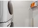 Practical laundry room with stacked washer and dryer, and storage shelves at 6682 Sterling Dr, Atlanta, GA 30328