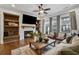 Stylish living room with modern furnishings, a fireplace, a mounted TV, and sliding doors that open to an outdoor balcony at 6682 Sterling Dr, Atlanta, GA 30328