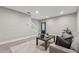 Open living room with gray walls, a staircase, and modern furnishings at 6682 Sterling Dr, Atlanta, GA 30328
