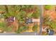 Aerial view of a home nestled among autumn trees, showcasing its roof, driveway and neighborhood at 12 Remington Ct, Euharlee, GA 30145