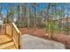 Backyard with wooden deck featuring railings and stairs overlooking a woodsy landscape at 12 Remington Ct, Euharlee, GA 30145