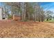 Exterior shot of a wood storage shed and backyard with mature trees at 12 Remington Ct, Euharlee, GA 30145