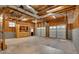 Unfinished basement with two garage doors, built in cabinets, and open ceiling at 12 Remington Ct, Euharlee, GA 30145