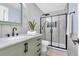 Stylish bathroom with marble tile, glass enclosed shower, updated fixtures, and a light green vanity at 12 Remington Ct, Euharlee, GA 30145
