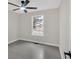 Bright bedroom with a ceiling fan, gray floors, natural lighting, and white trim at 12 Remington Ct, Euharlee, GA 30145