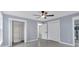 Bedroom with a ceiling fan, ensuite bath, and closet with shelving for storage at 12 Remington Ct, Euharlee, GA 30145