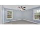 Bedroom with two windows, ceiling fan and neutral color palette at 12 Remington Ct, Euharlee, GA 30145