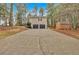 Wide shot of home exterior showing long driveway, black garage doors and a storage shed at 12 Remington Ct, Euharlee, GA 30145