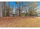 Quaint home surrounded by trees features a cozy front porch and charming architectural details at 12 Remington Ct, Euharlee, GA 30145