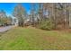 View of the grassy front lawn leading to a charming house with a shed on a sunny day at 12 Remington Ct, Euharlee, GA 30145