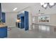 Open-concept kitchen with blue cabinets, stainless appliances, adjacent to dining room with vaulted ceilings at 12 Remington Ct, Euharlee, GA 30145