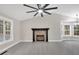 Open living room showcases fireplace, vaulted ceilings, and large windows for natural light at 12 Remington Ct, Euharlee, GA 30145