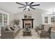 Comfortable living room with fireplace, vaulted ceilings, ceiling fan, and view to dining area at 12 Remington Ct, Euharlee, GA 30145