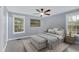 Cozy main bedroom features neutral decor, a ceiling fan, and windows offering natural light at 12 Remington Ct, Euharlee, GA 30145